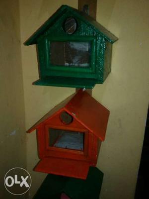 Two Red And Green Wooden Birdhouses