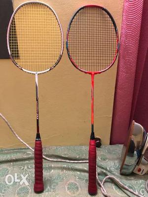 Two White And Red Badminton Rackets