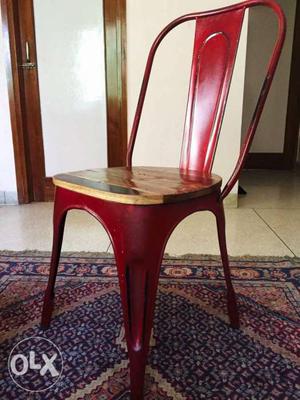 1yr old red metal chair, wooden seat. solid,