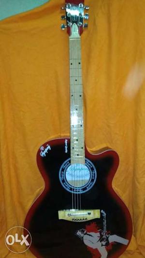 Symphony Black & Red acoustic guitar with cover.