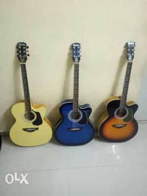 Yellow, Blue, And Sunburst Single-cutaway Acoustic Guitars