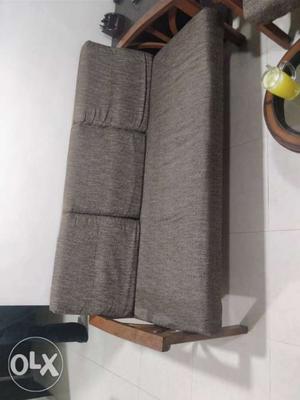 Brown wooden sofa. With covers.