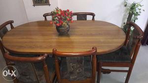 Saal wood made oval shaped dining table with six cusion