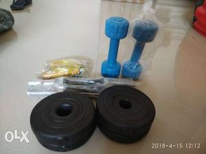 Two Blue Dumbbells And Four Black Weight Plates