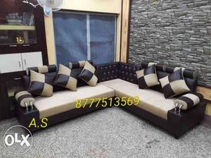 Beige And Black Leather Sectional Couch And Throw Pillows