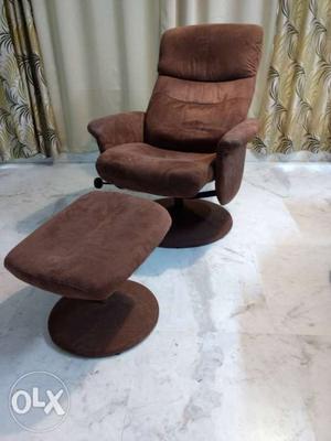 Sparingly used fafric recliner with footbed.
