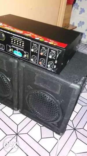 Two Black Subwoofers With Enclosures And Blakc Stereo