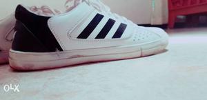 Paired White And Black Adidas Shoe