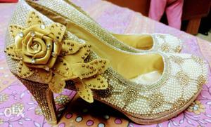 The golden heels and black wedges for sale.its