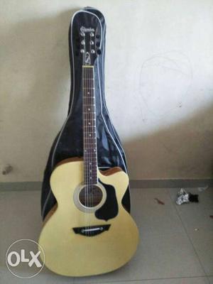 Beige And Black Acoustic Guitar With Black Gig Bag