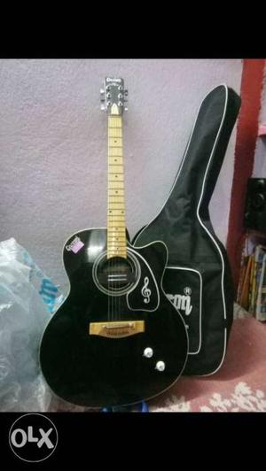 Black unused acoustic guitar