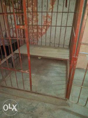 A dog house heavy iron bars with single door a for your