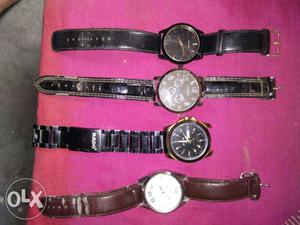 Four Round Watches With Leather Straps