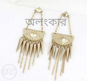 Goldand silver colored dangle earring.