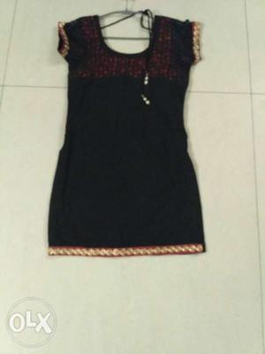 Smart black kurti with pink contrast on the neck,