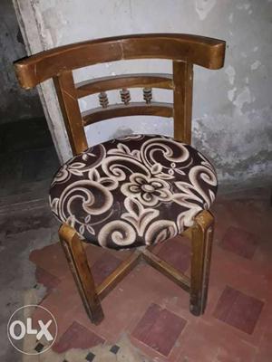 Brown Wooden Chair With White And Black Floral Pad