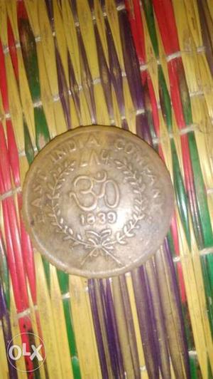 Round Copper-colored OM Coin