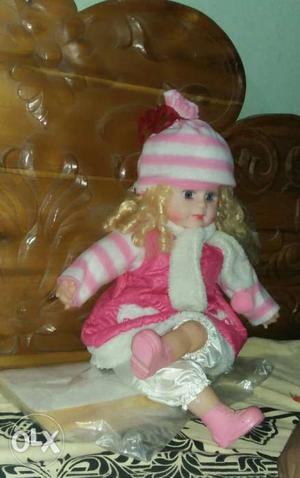 Doll Wearing Pink And White Knit Cap