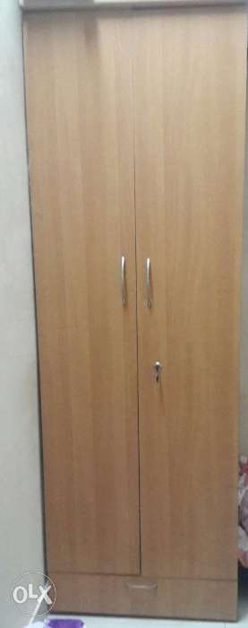 Double door wooden wardrobe with extra drawer at