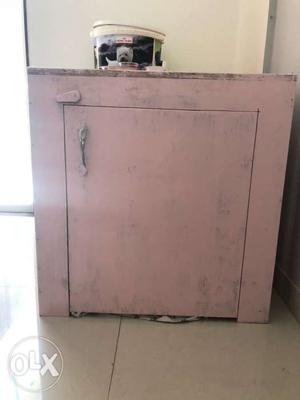 Wooden dog cage painted in baby pink. Perfectky