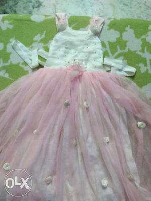 A baby pink coloured beautiful frock with flower
