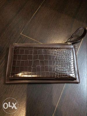 Brown coloured leather made clutch bag