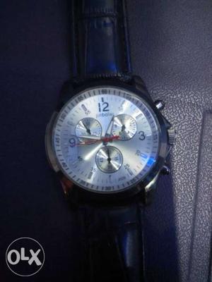 Round Silver Chronograph Watch With Black Leather Strap
