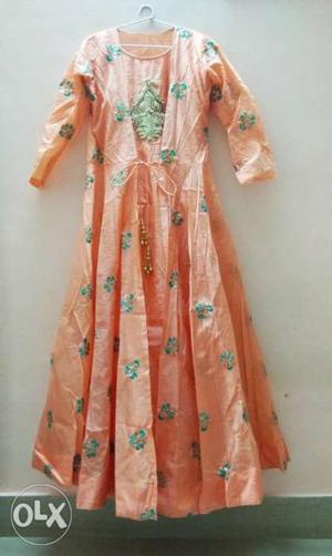 Simple peach gown with lovely designs. Fresh product. Not