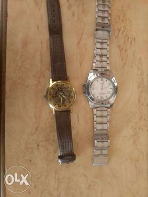Two Round Silver Chronograph Watches With Black Leather