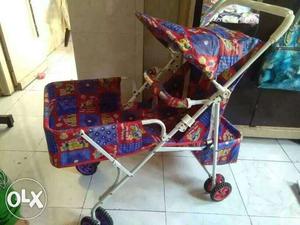 Baby's Red And Blue Stroller