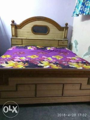Brown Wooden Bed Frame With Pink Floral Bed Sheet