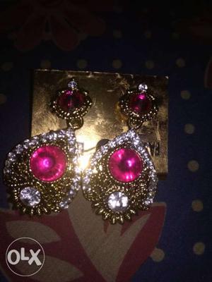 Pair Of Gold-colored Earrings With Pink And Clear Gemstones