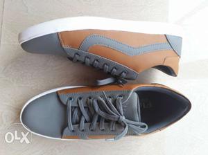 Pair Of Gray-and-black Low Top Sneakers