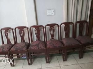 Four Brown Wooden Framed Padded Chairs