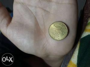 Round Gold-colored 10 Cent Coin