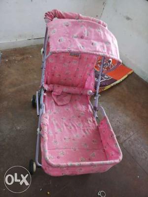Baby's Pink And Grey Stroller