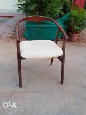 Wodden chair with polish and upholstery..