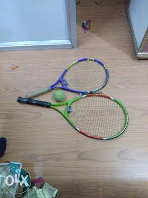 Two Blue And Green Tennis Rackets