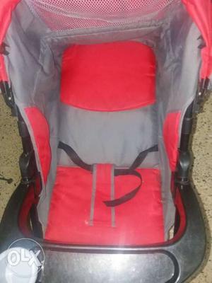 Baby's Red And Grey Stroller