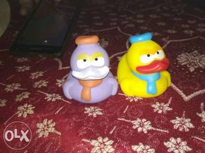 Two Purple And Yellow Rubber Ducks