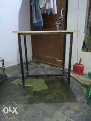 Brown Wooden Table With Black Steel Ase