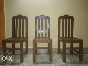 Three Brown Wooden Armless Chairs