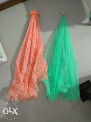 Two Green And Orange Mosquito Net Canopies