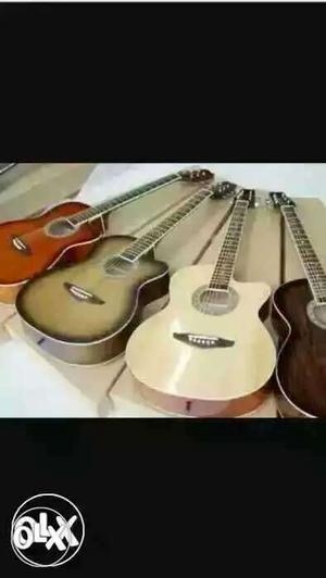 Brown, Green, Beige, And Black Acoustic Guitars