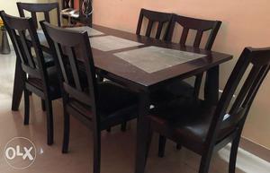 Solid wood, 5 feet by 3 feet table with 6 chairs,