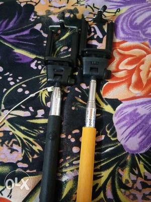 Two Yellow And Black Handled Selfie Sticks