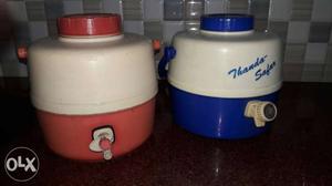 Two Red And Blue Plastic Water Jugs