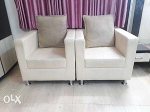 White Fabric Two Sofa Chairs With Throw Pillows