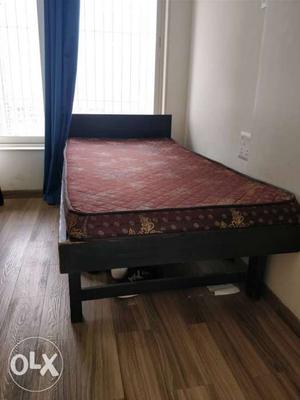 Wooden bed with mattress, good condition.