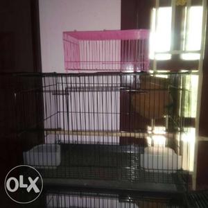 Two Black And Pink Metal Pet Cages